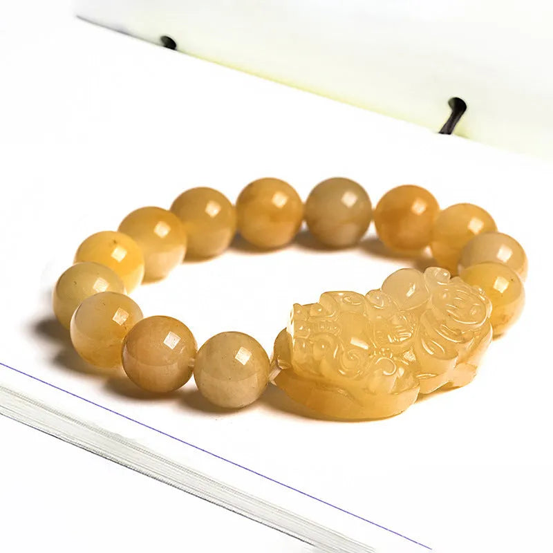 Hand-carved Jinsi Jade money bracelet showing golden thread patterns with jade beads