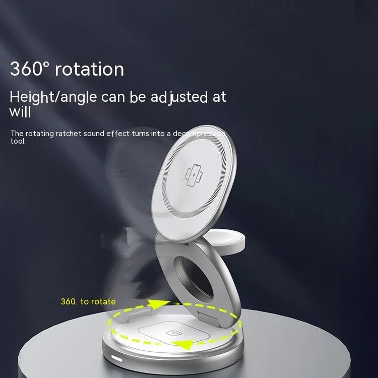 3-in-1 wireless charger magnetic folding stand in grey with phone and headphones charging on a desk