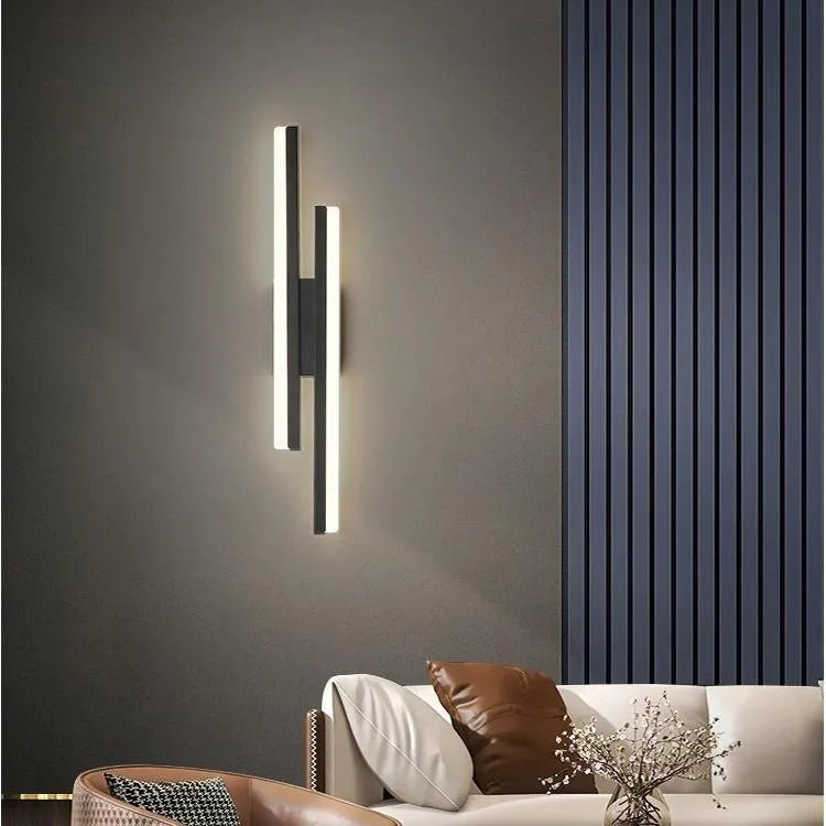 Minimalist Scandinavian LED wall light with black metal arm and white acrylic shade mounted on a wall.