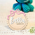 Square wooden baby room ornament with space for a customised name, shown in two size options.