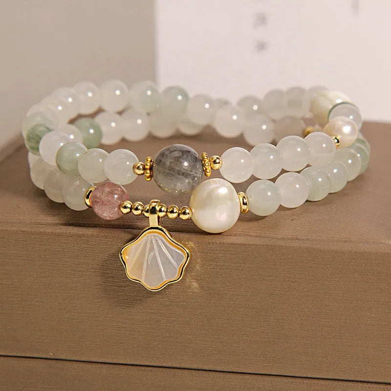 Women's crystal bracelet with gold-plated inlay, gemstones, and a Tianshan Jade ginkgo leaf pendant.
