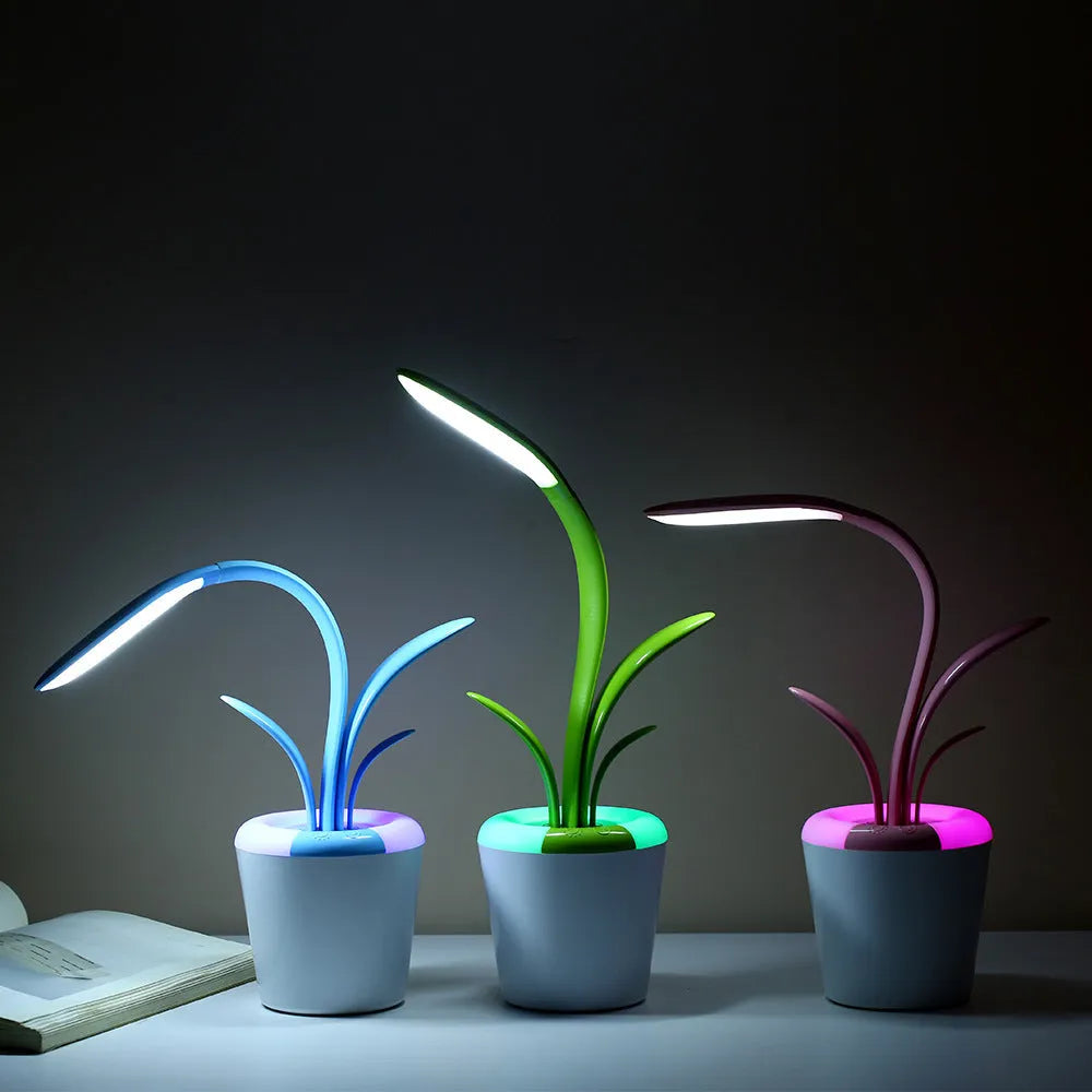 Modern rechargeable LED table lamp in blue with stylised plant shape on end table
