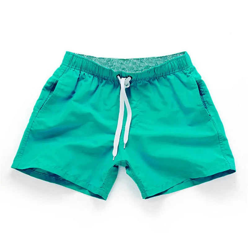 Men's black polyester beach shorts with a straight leg, shown on a size chart with options up to 4XL.