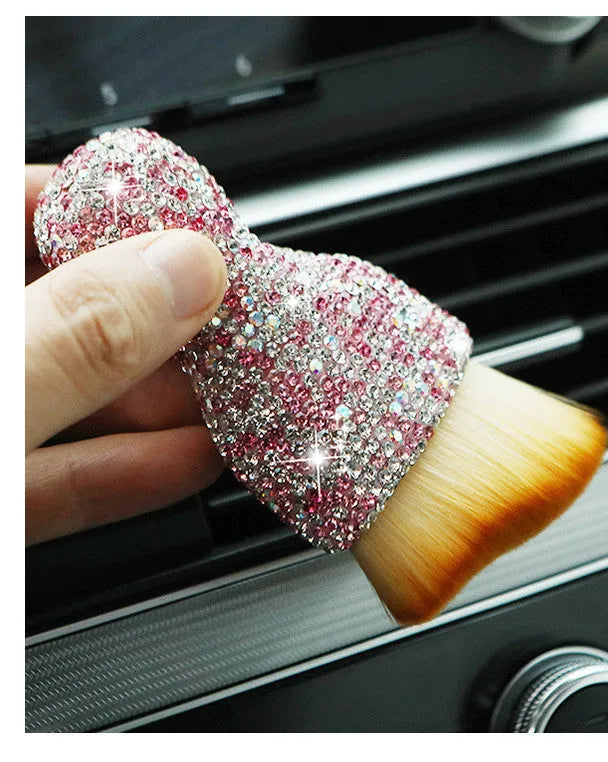 White PVC car interior cleaning brush on a car dashboard, showing its compact size and soft bristles.