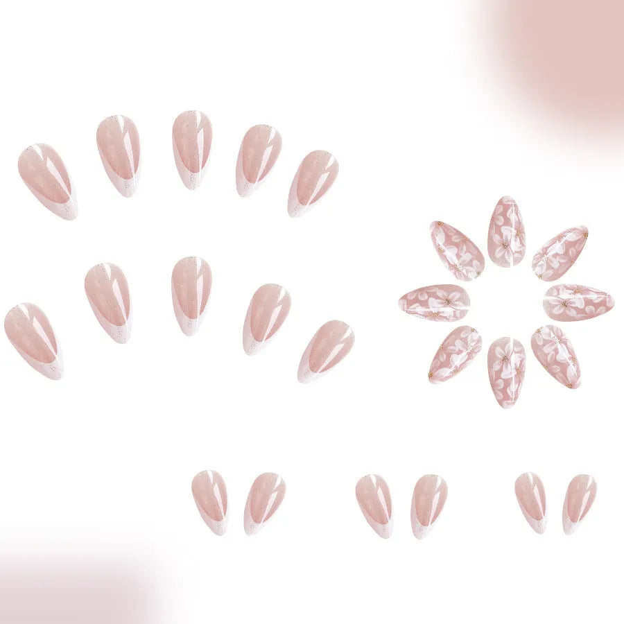 Short almond-shaped false nails with French tips and glitter powder flower decoration
