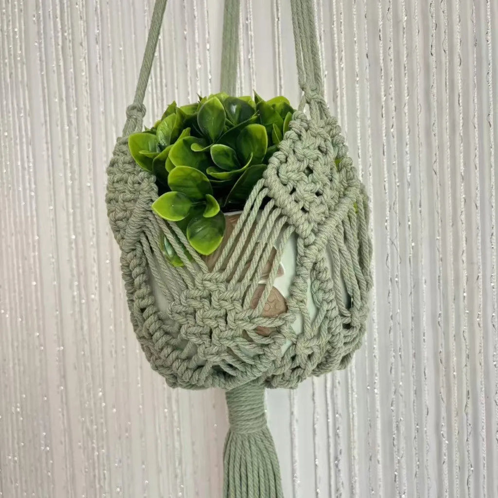 Hand-woven brown polyester cotton flower pot with net pocket cord holding a green plant.