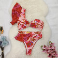 Women's pink one-shoulder ruffled swimsuit with red flower print and high-waisted briefs