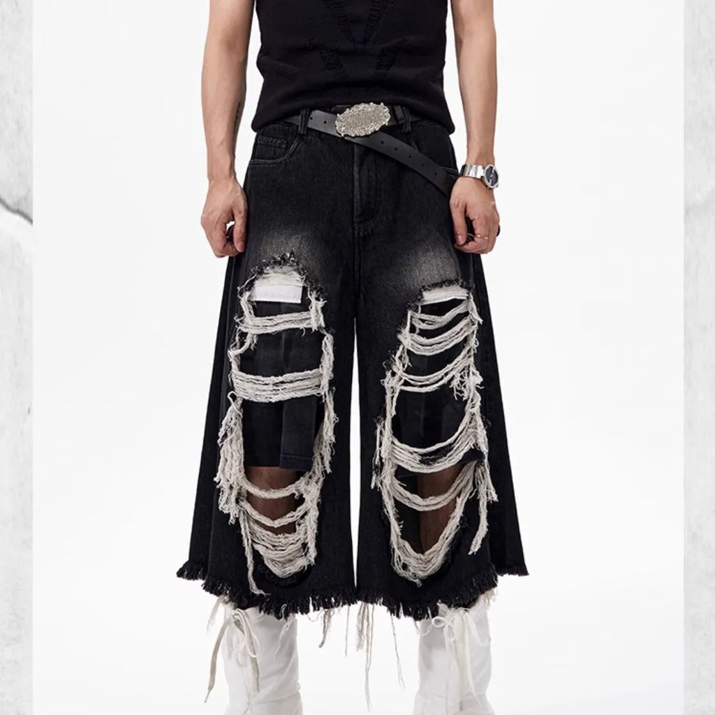 Black cropped wide-leg jeans with mid-high waist on mannequin showing loose fit and micro-elastic cotton denim