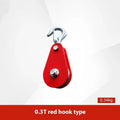 Red industrial single sheave lifting pulley with a forged steel hook and safety latch.