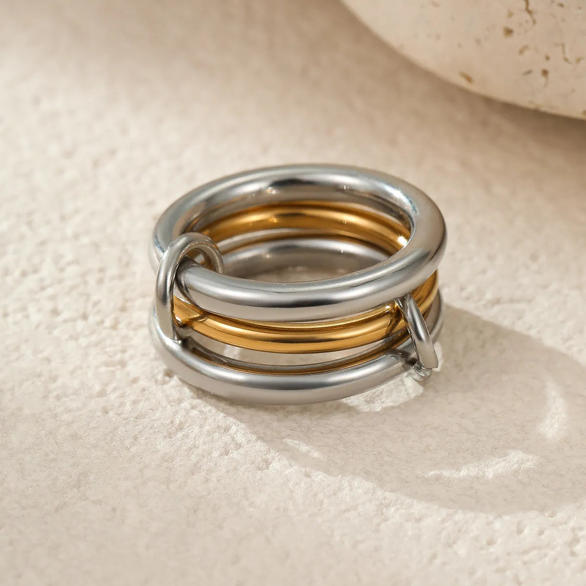 Three stacked stainless steel rings with 18K gold plating in matching design