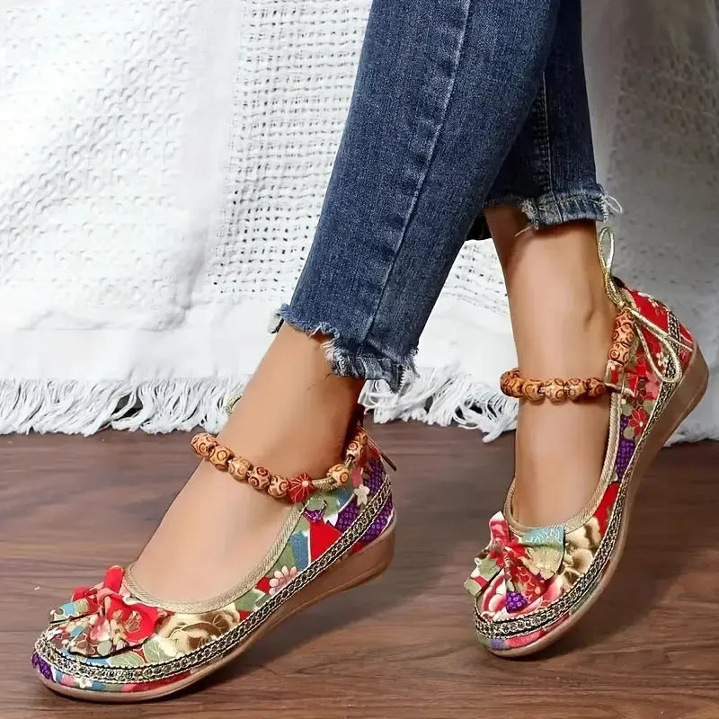 Women's black ethnic platform sandals with elastic band and cloth upper on a plus size foot.