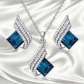 Glass pendant necklace with cross chain and matching electroplated alloy ear studs jewellery set
