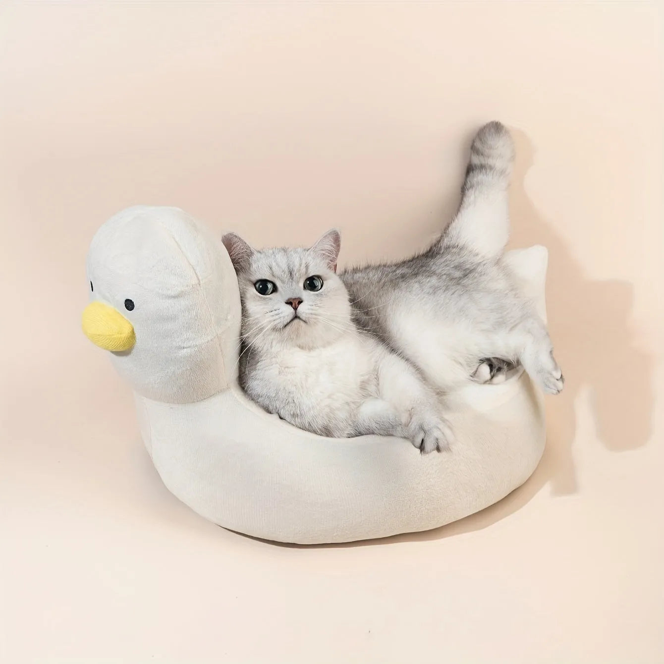 Blue duck-shaped fluffy pet bed for small dogs and cats on a floor