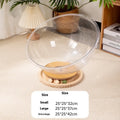 Transparent acrylic space capsule shaped cat bed on a turntable base, shown in a large size.