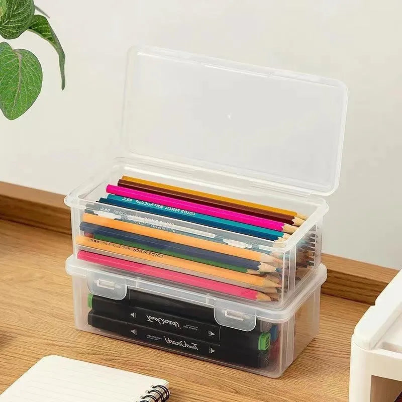 Clear plastic pencil storage box with large capacity for organising stationery and children's art supplies.