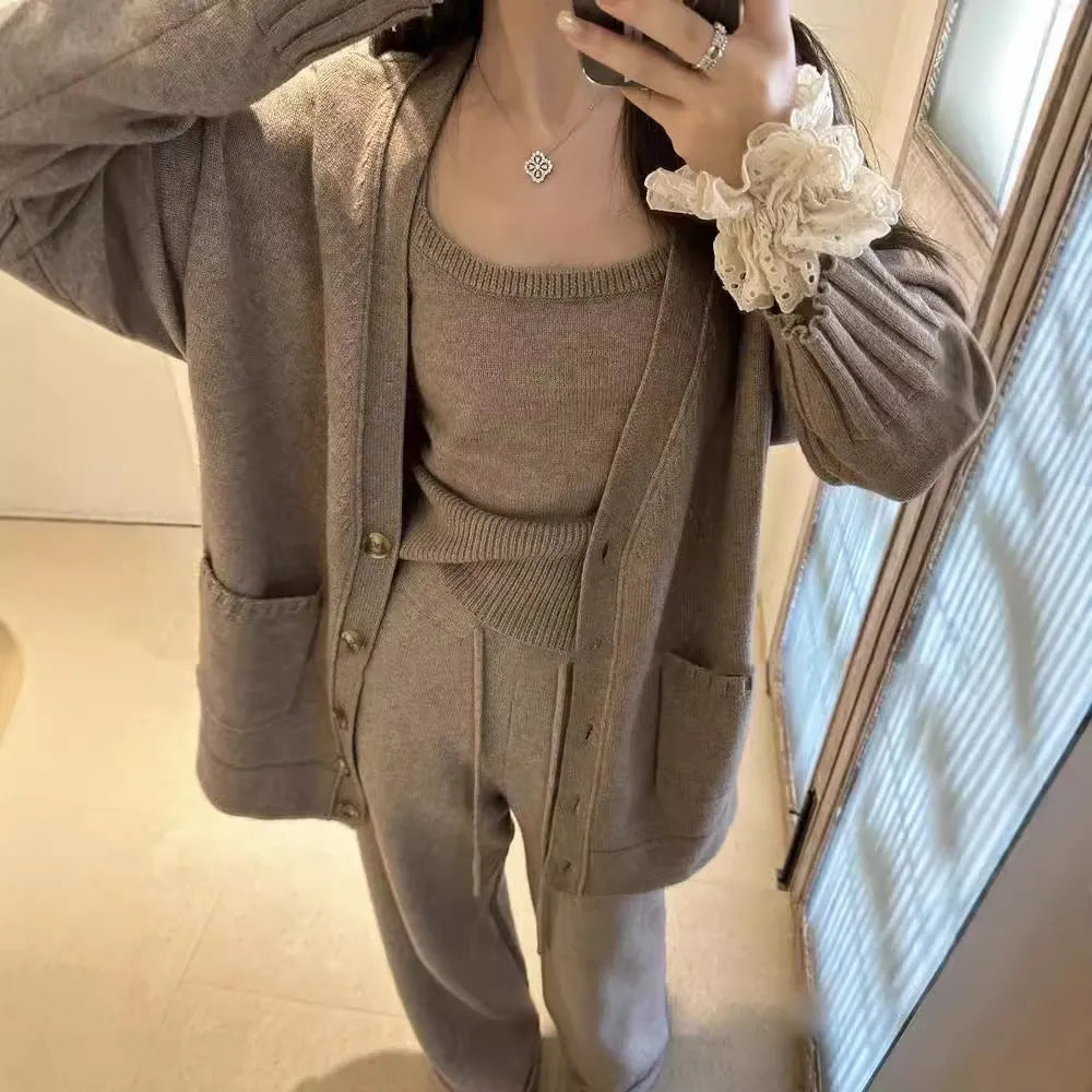Women's light brown knit cardigan and suspender pants three-piece casual set on a hanger.