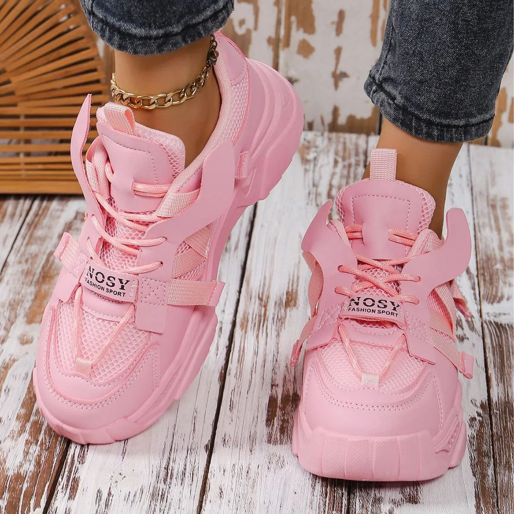Women's purple and white platform mesh sports sneakers with front lace-up design on a plain background.