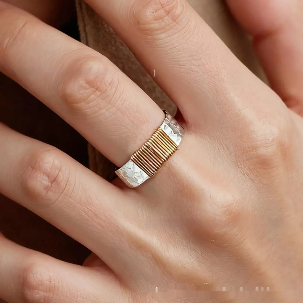 Simple geometric ring bracelet in electroplated copper with silver gold coil finish showing irregular coil design