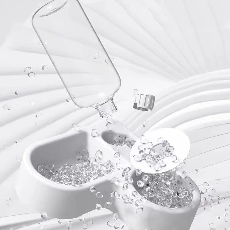 White food-grade plastic pet water fountain for cats and dogs on a countertop.