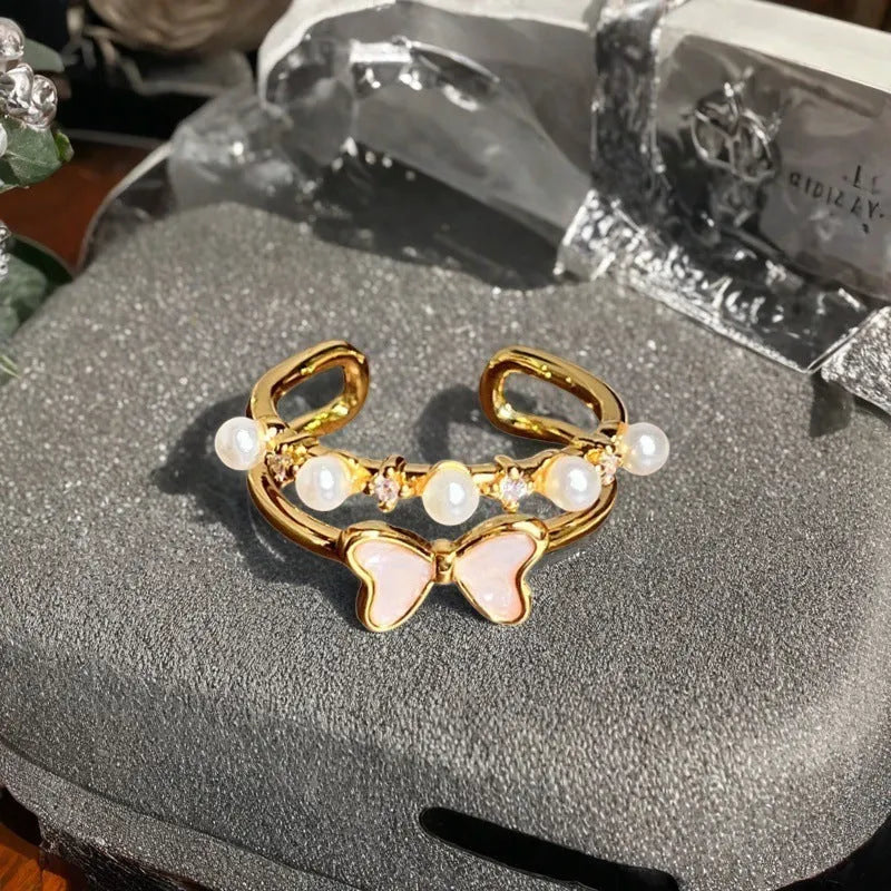 Adjustable vintage-style copper ring with gourd, flower, and bow design featuring inlaid zircon stones.