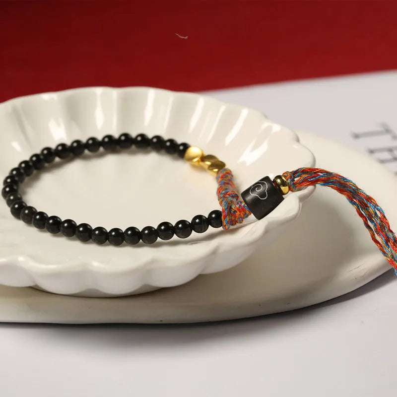 Hand-woven obsidian carrying strap showing 4mm width and textured surface