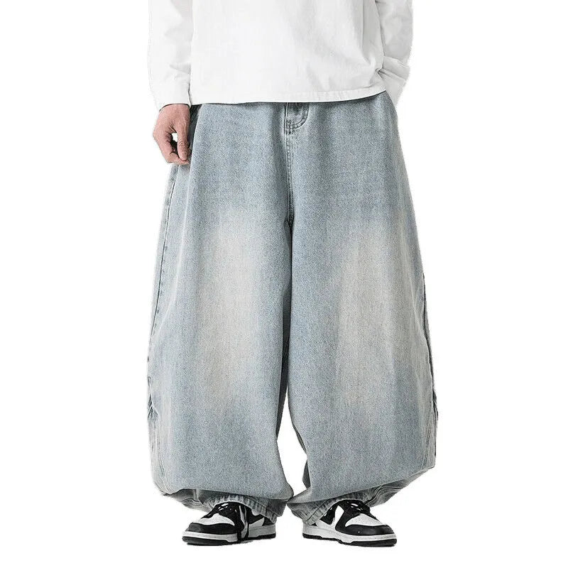 Men's plus size baggy jeans in light blue denim with wide straight legs and a low waist.