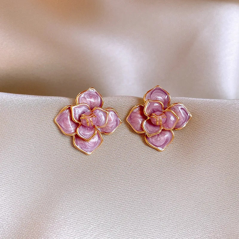 Gold plated flower stud earrings with a purple oil-spot glaze finish on copper.