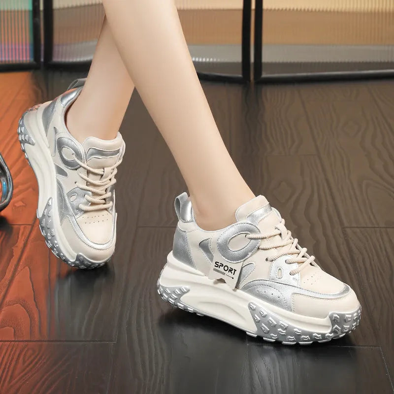 A pair of leather casual shoes with a thick wedge sole, round toe, and front lace-up design.