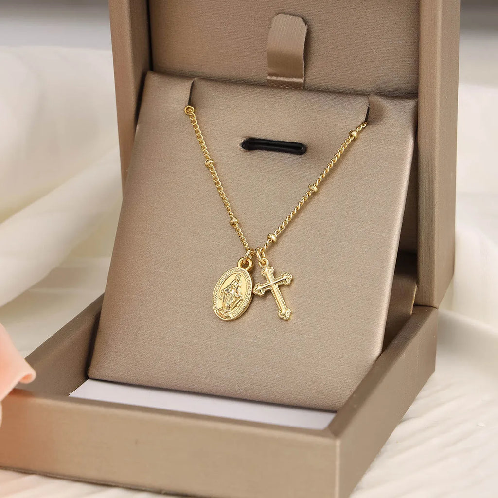 Gold cross Virgin Mary pendant necklace with geometric design on adjustable chain for women