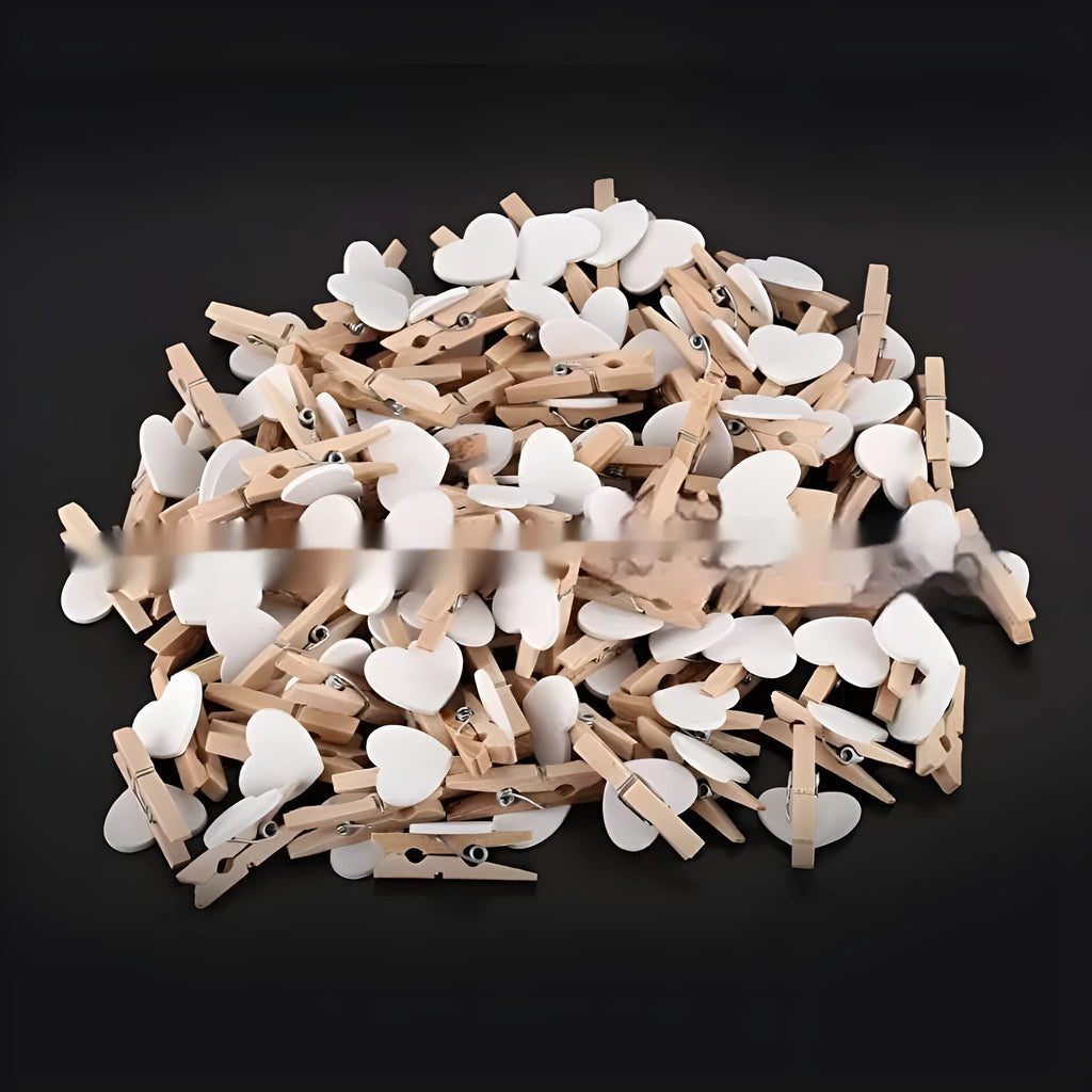 Set of five solid wood heart-shaped clips in red, white, and rose red on a plain surface.
