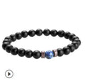 Natural moonstone and agate bead bracelet with lava stone diffuser and Tibetan Buddha charm on white background
