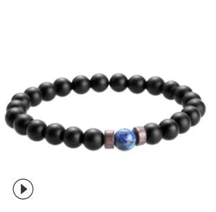 Natural moonstone and agate bead bracelet with lava stone diffuser and Tibetan Buddha charm on white background