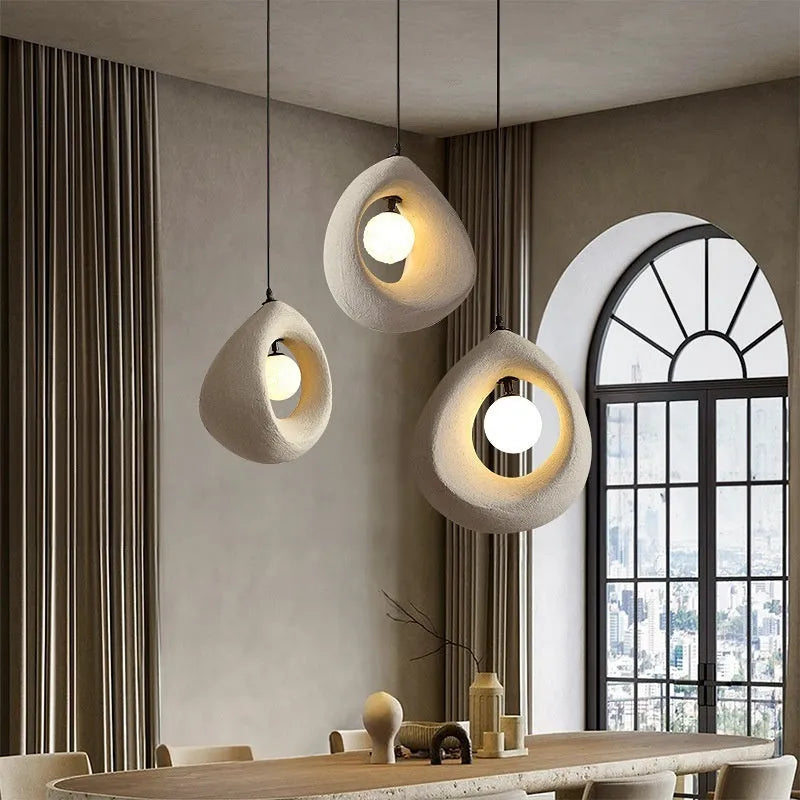 Modern pendant ceiling light with a wide milky white glass shade in a retro chandelier style.
