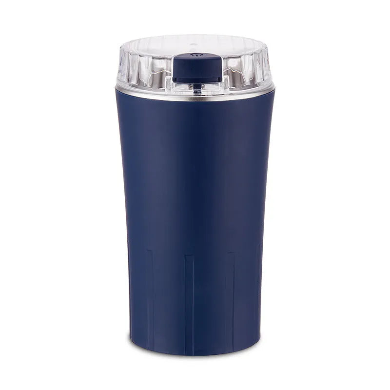 Blue manual mini flour mill and grinder for chili, pepper, and grains on a kitchen counter.