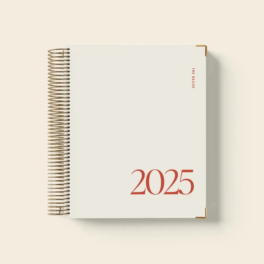 Cherry red A5 daily schedule coil notebook showing spiral binding and open pages