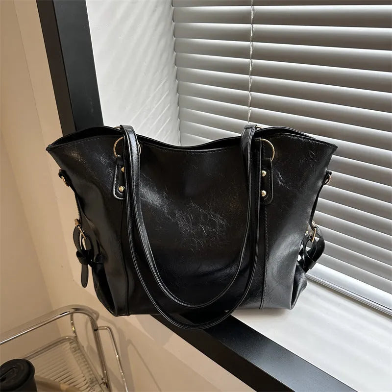 New retro commuter tote bag in soft PU, black colour, bucket shape with visible stitching and double shoulder straps