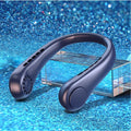 Portable bladeless neck fan in white hanging around neck with USB charging cable