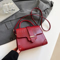 Ladies PU crossbody bag in black with single strap and medium-hardness shape