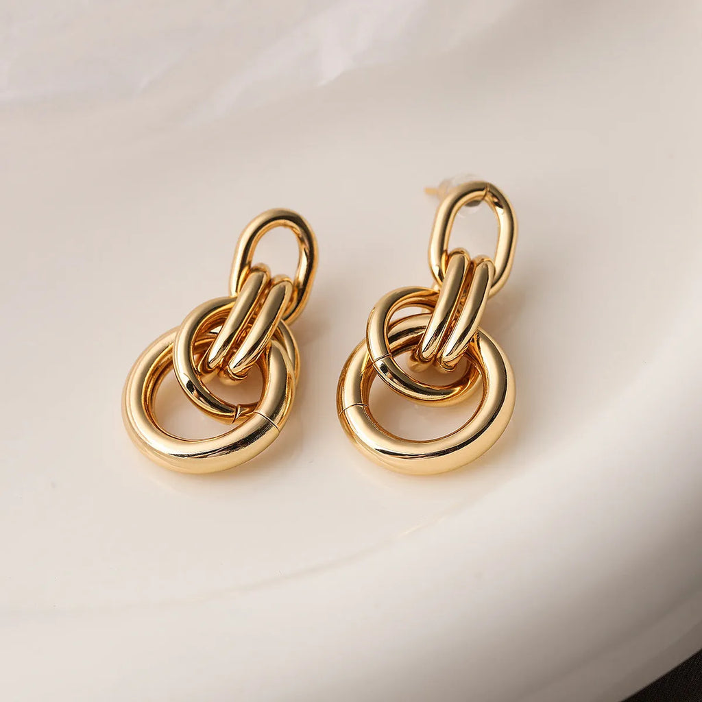 Women's geometric copper earrings with gold colour finish and irregular shapes