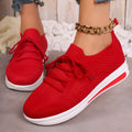 Women's black fly-knit style casual sneakers with lace-up front and low-top design.