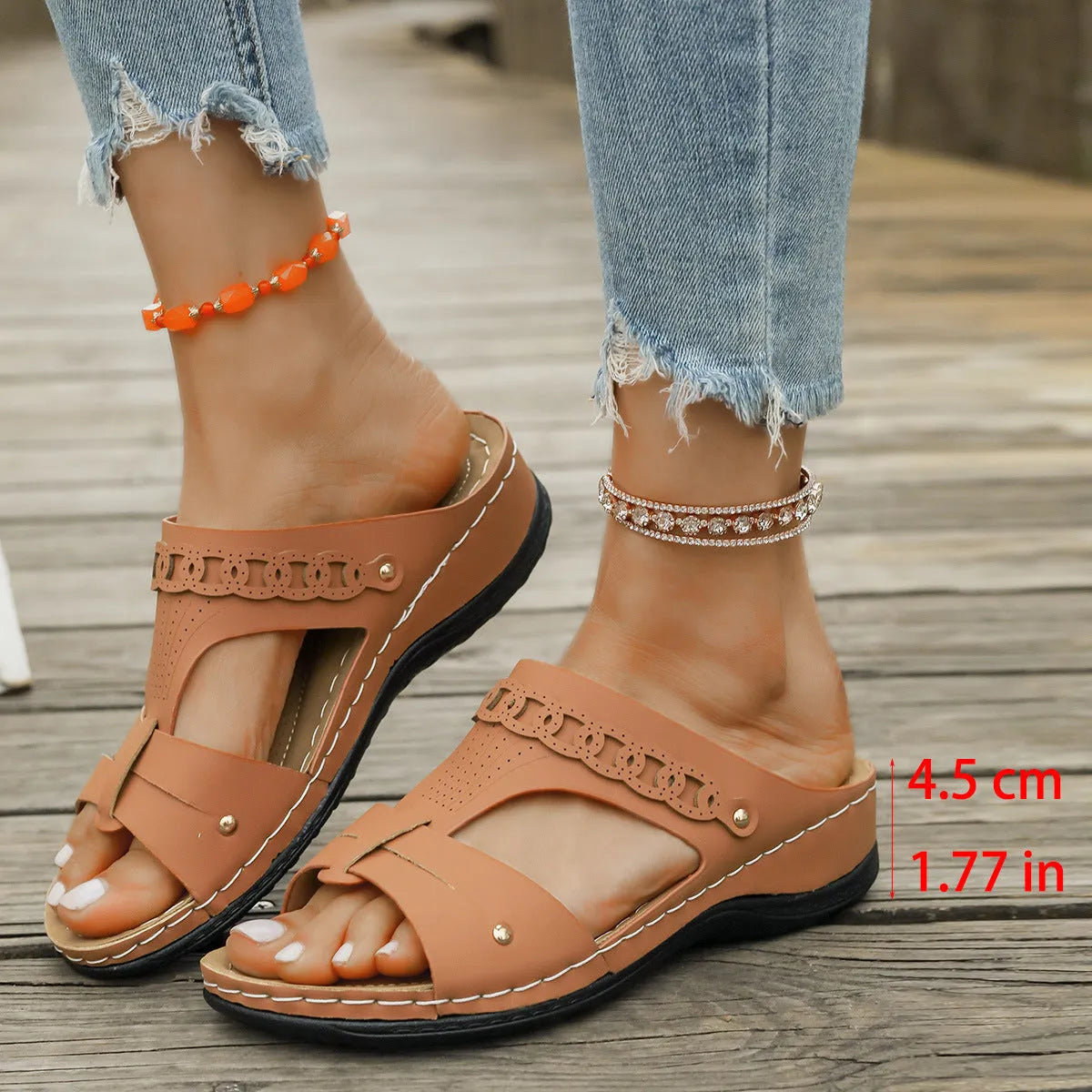 Blue roman style slippers with fish mouth toe and slope heel on a rubber sole.