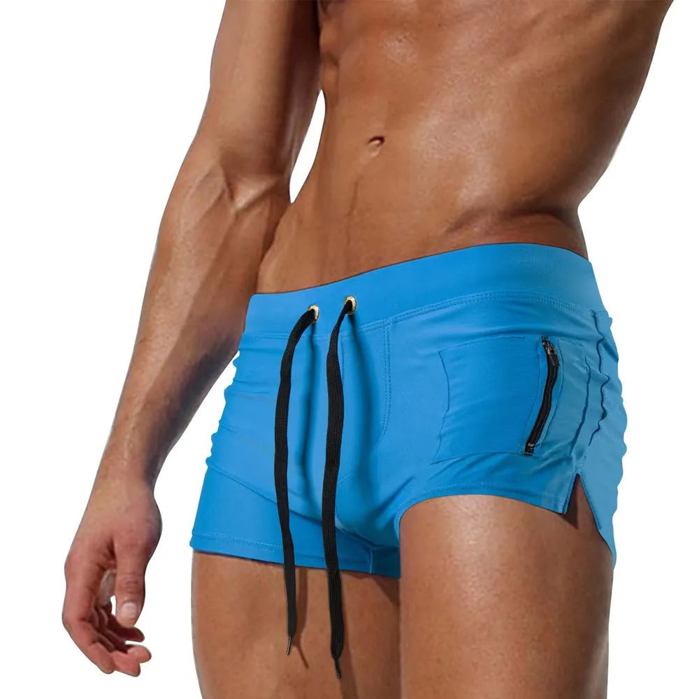 Men's black high-waist swimming trunks with a lace-up front closure on a white background.