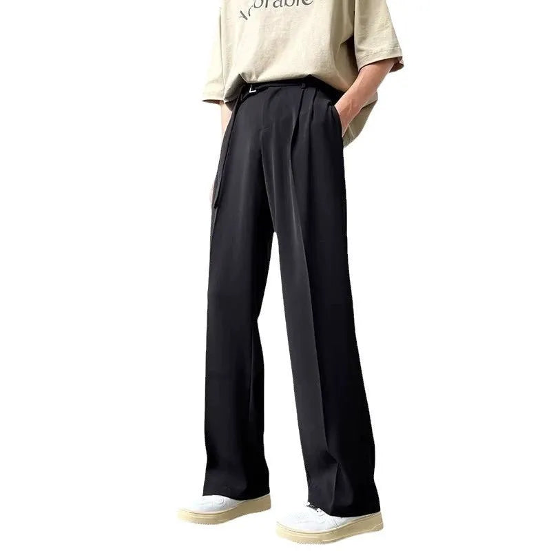 A pair of thin, black, loose-fit wide leg trousers with a straight leg opening, laid flat.