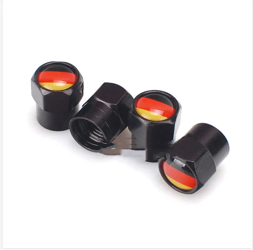 Set of four black metal aluminium alloy valve caps with German flag design on white background