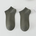Men's solid colour low-cut boat socks made from polyester fibre on a plain background.