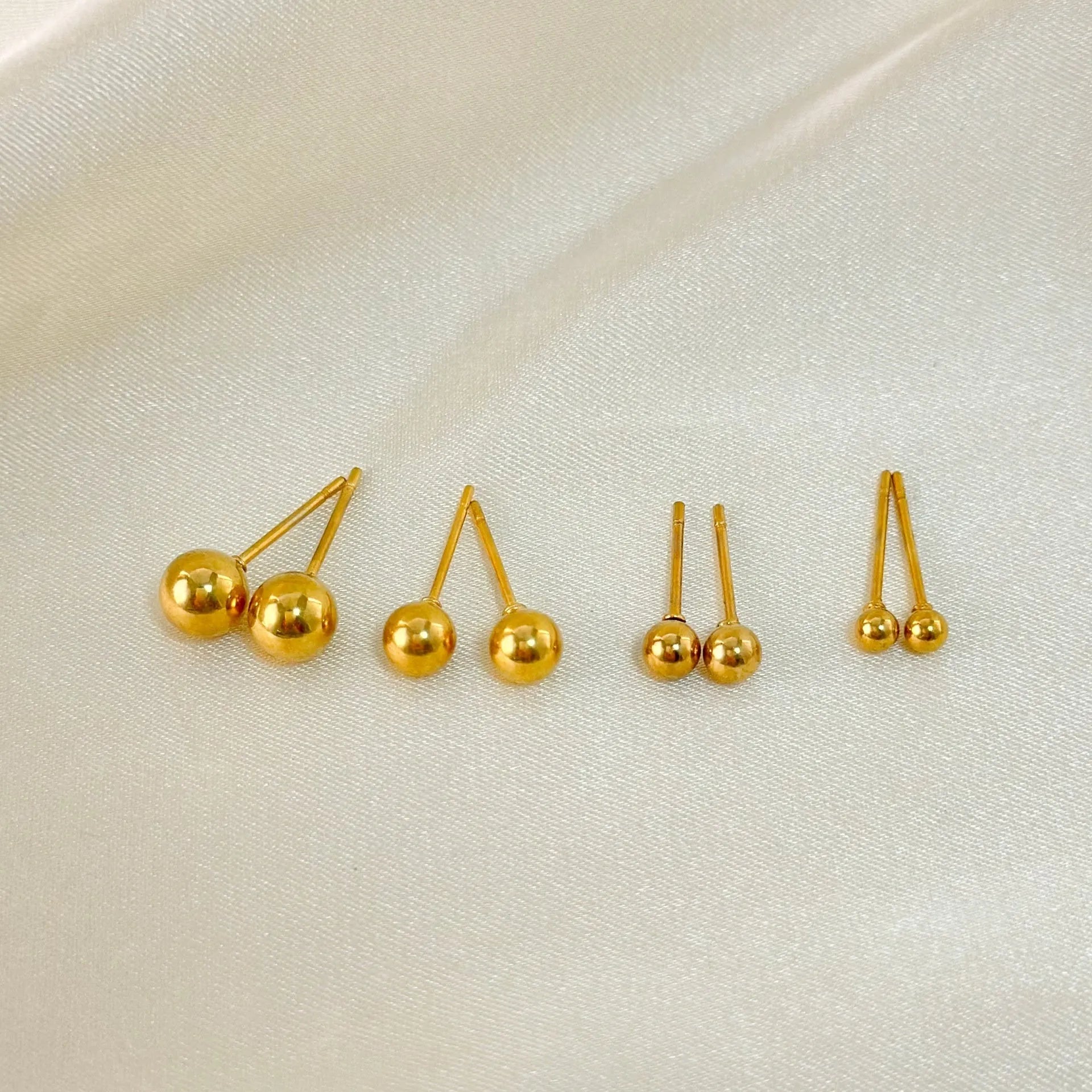 Stainless steel ball stud earrings with gold or silver plating in 3mm, 4mm, 5mm, and 6mm sizes
