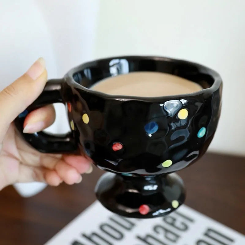 Hand-pinched irregular ceramic mug in a solid colour, shown from the side.