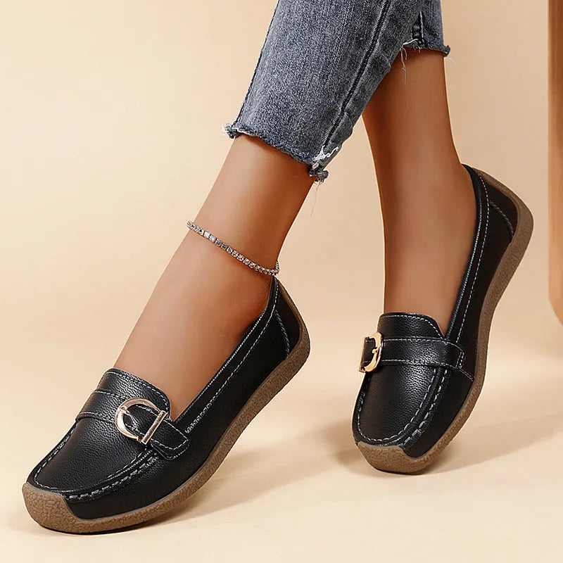 Women's beige casual loafers with round toe, flat heel, and slip-on design on a plain background.