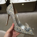 Gold women's pointed toe high heels with rhinestone decoration and a stiletto heel.