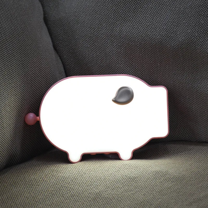 Blue and pink multifunctional LED digital alarm clock displaying time and temperature, with USB charging cable